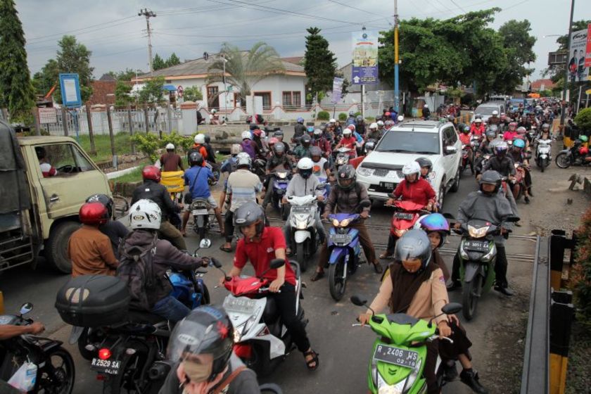 BEREBUT CEPAT: Kondisi perlintasan sebidang Jalan Jenderal Soedirman yang selalu padat. Para pengendara roda dua banyak yang berebut cepat dengan melanggar barier yang sudah dipasang. DIMAS PRABOWO/RADARMAS